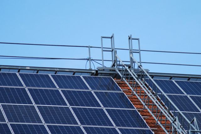 Solar panels on a rooftop with a roof access ladder